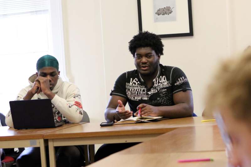 a group of men sitting at a table