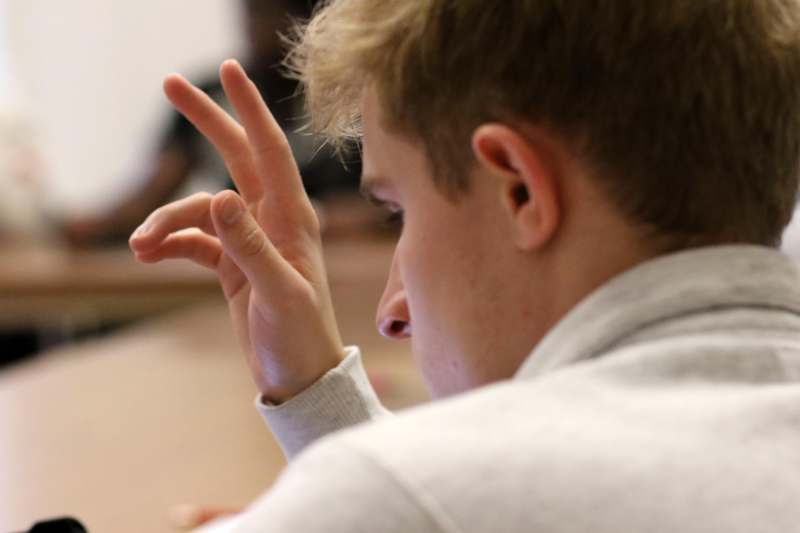 a man holding up his fingers