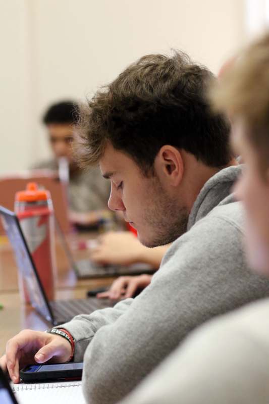 a man sitting at a table with his eyes closed