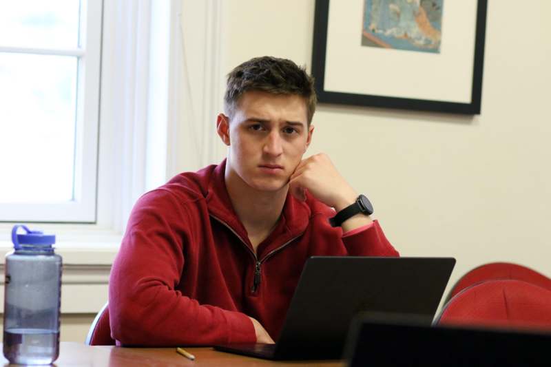 a man sitting at a table with a laptop