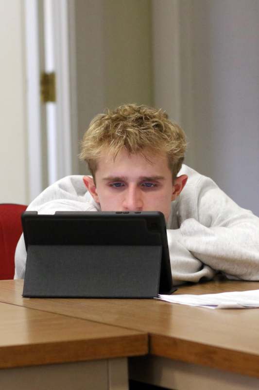 a man looking at a tablet