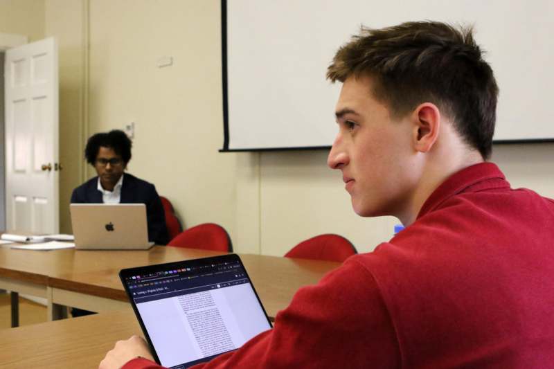 a man sitting at a table with a laptop