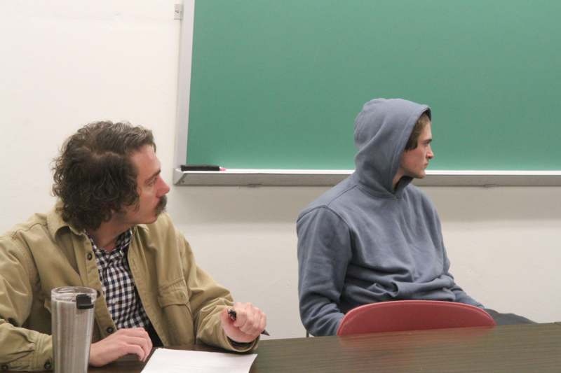Classroom: THE 203 with Brandon Thompson - a man sitting at a desk with a man in a hoodie