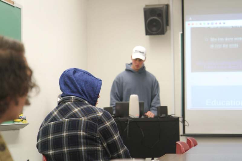 a man in a white cap standing in front of a man in a white hat