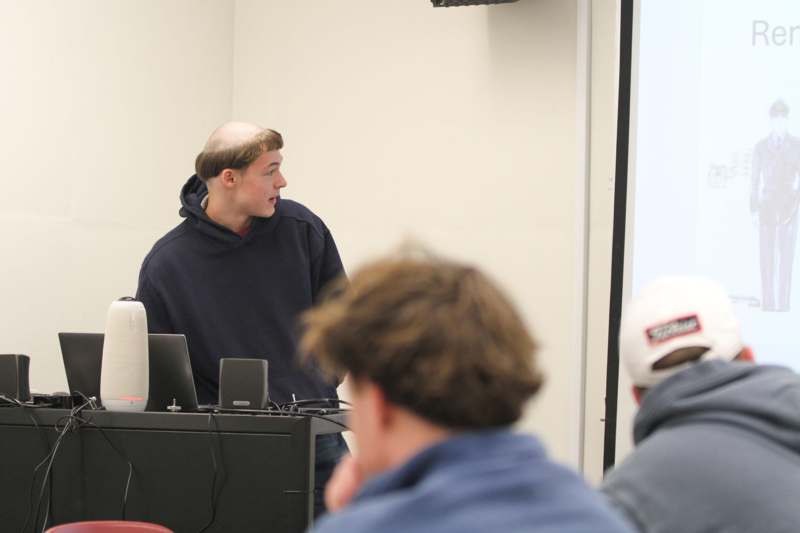 a man standing in front of a computer