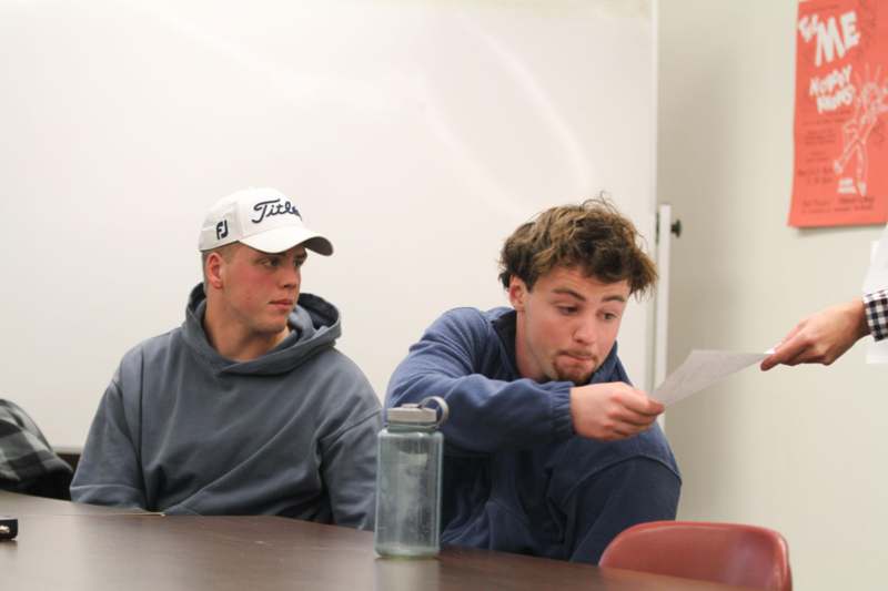 a man looking at a piece of paper