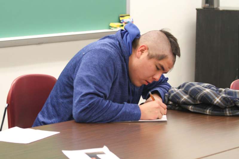 a man writing on a paper