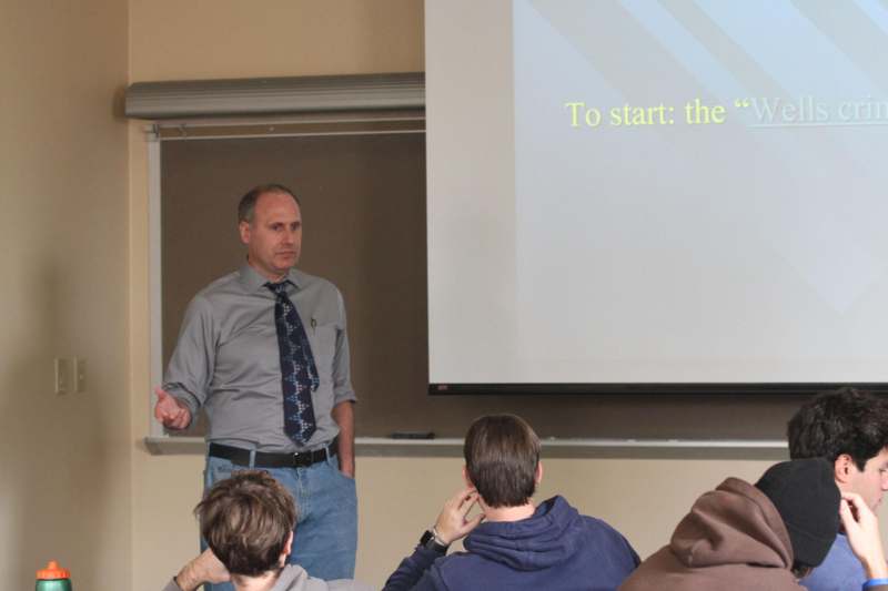 a man standing in front of a screen
