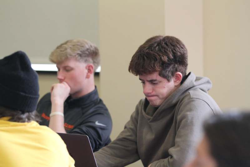 a group of men sitting at a table