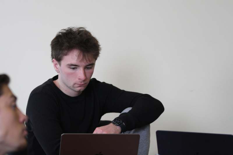 a man looking at a laptop