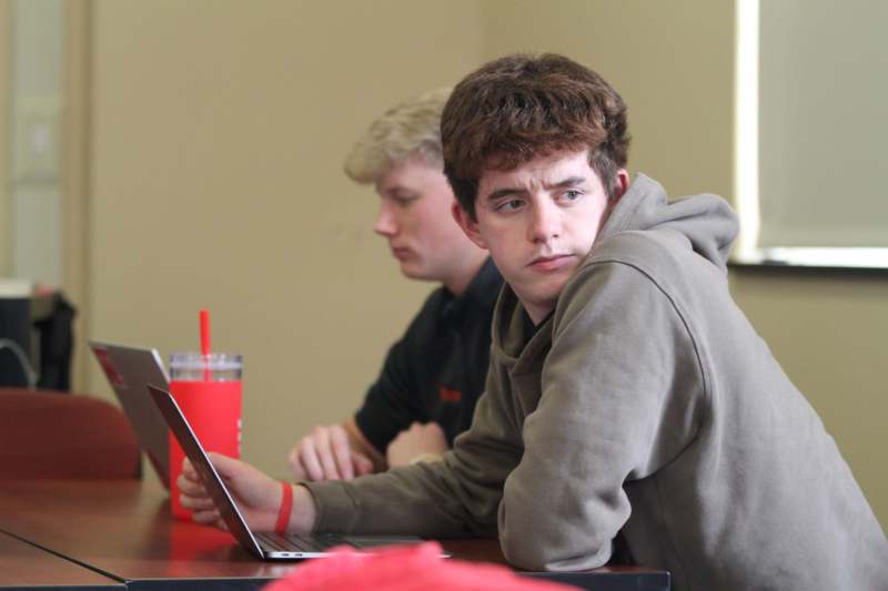 a man looking at a laptop