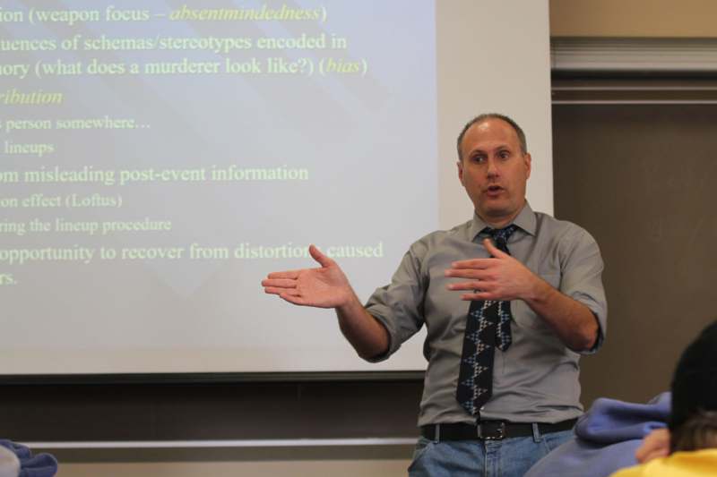 a man standing in front of a projection screen