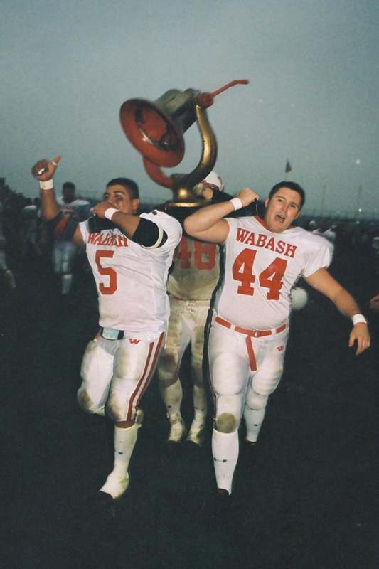 Back at the Bell - a football players holding a trophy