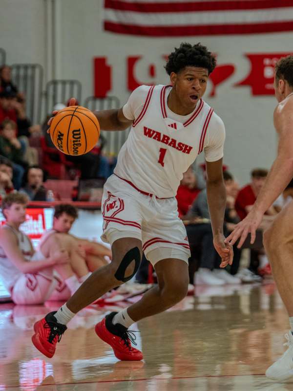 a basketball player in a white uniform with a ball in his hand