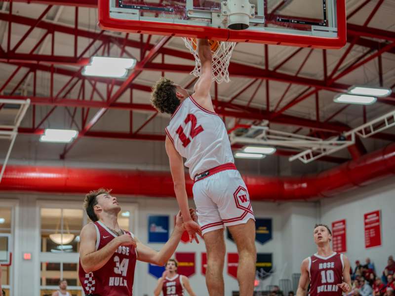 a group of men playing basketball
