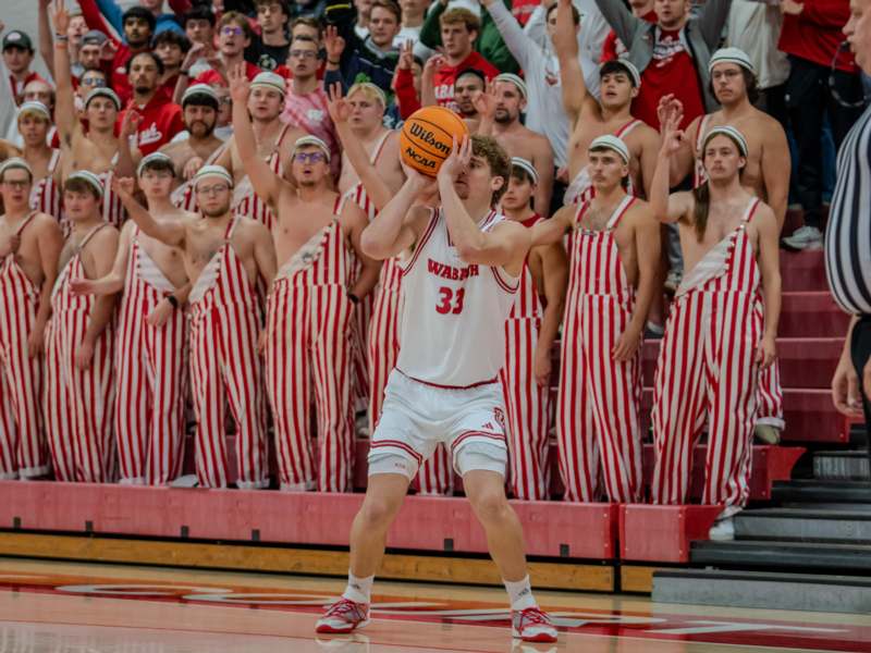 a basketball player in uniform with a ball in his hands