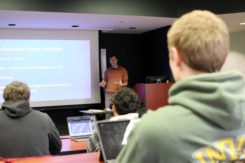 a man standing in front of a screen