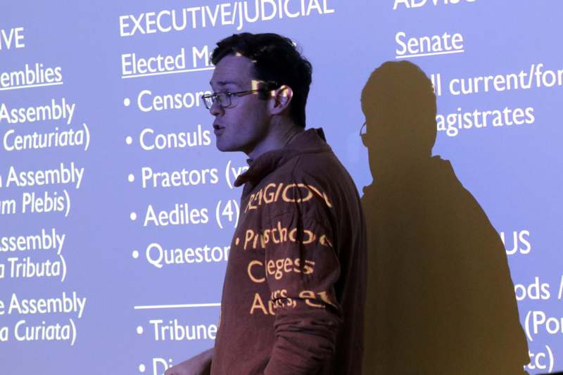 a man standing in front of a wall