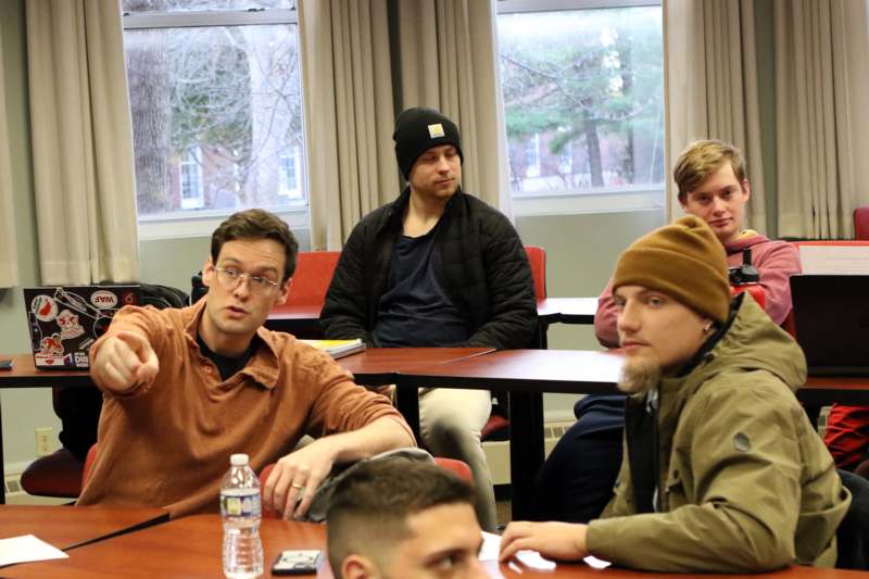 a group of men sitting at tables