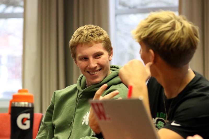 a group of young men sitting in a room