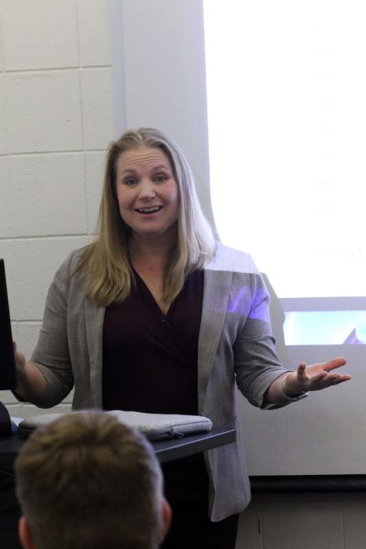 a woman standing in front of a computer