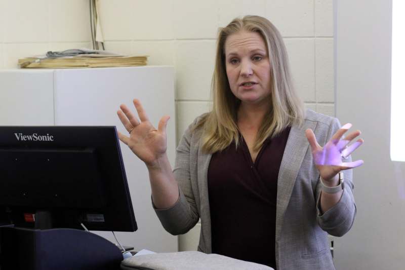 a woman in a suit with her hands up