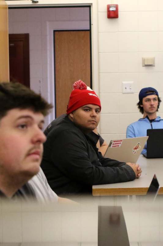 a group of men sitting at a table