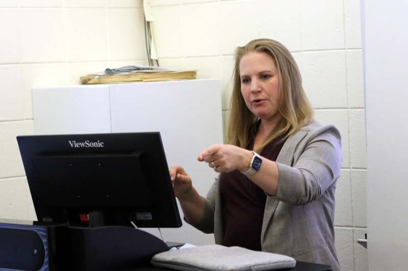 a woman standing at a computer