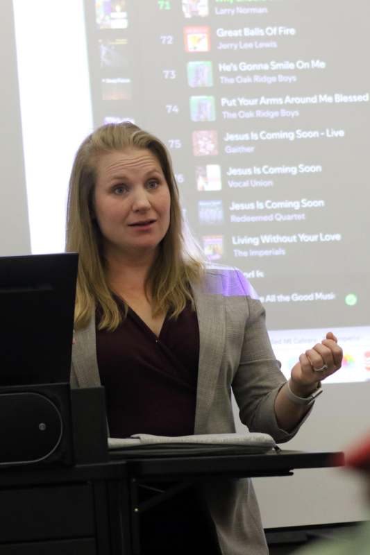 a woman standing in front of a screen