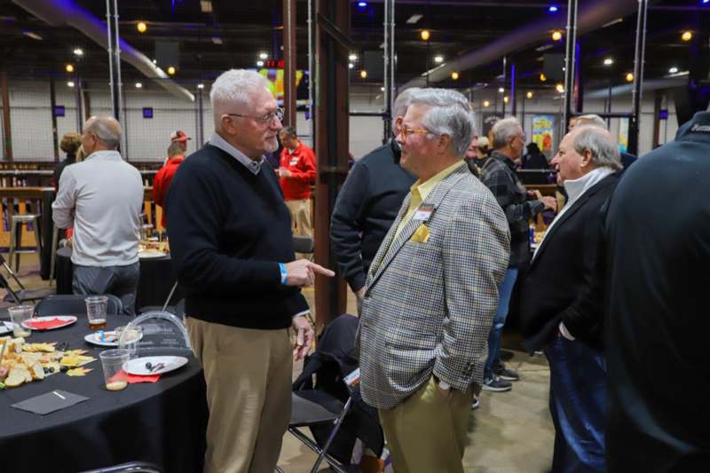 a group of men talking in a room