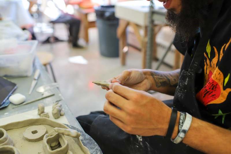 a man working on a clay piece