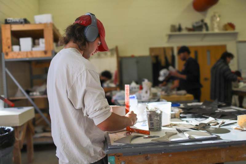a man wearing headphones working on a table