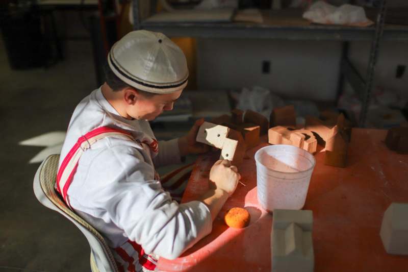 a man working on a piece of clay