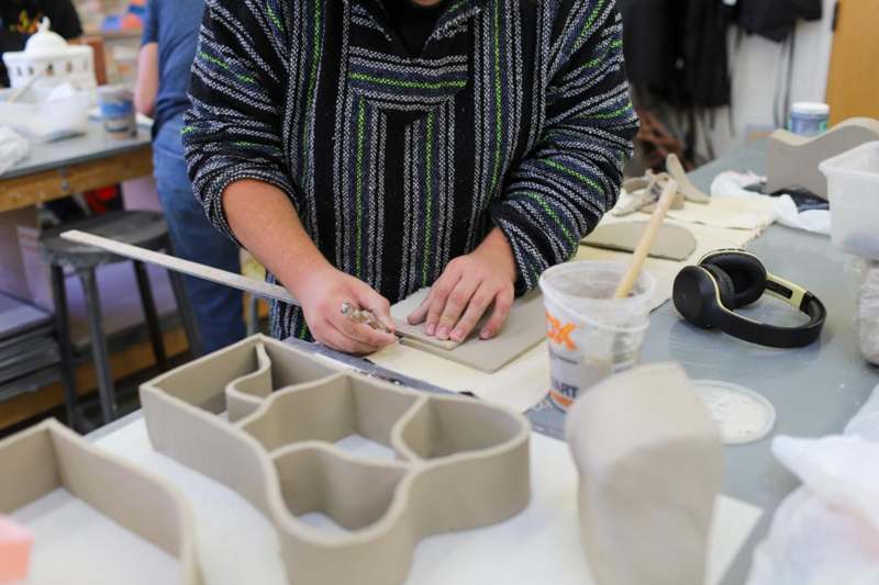 a person working on a clay sculpture
