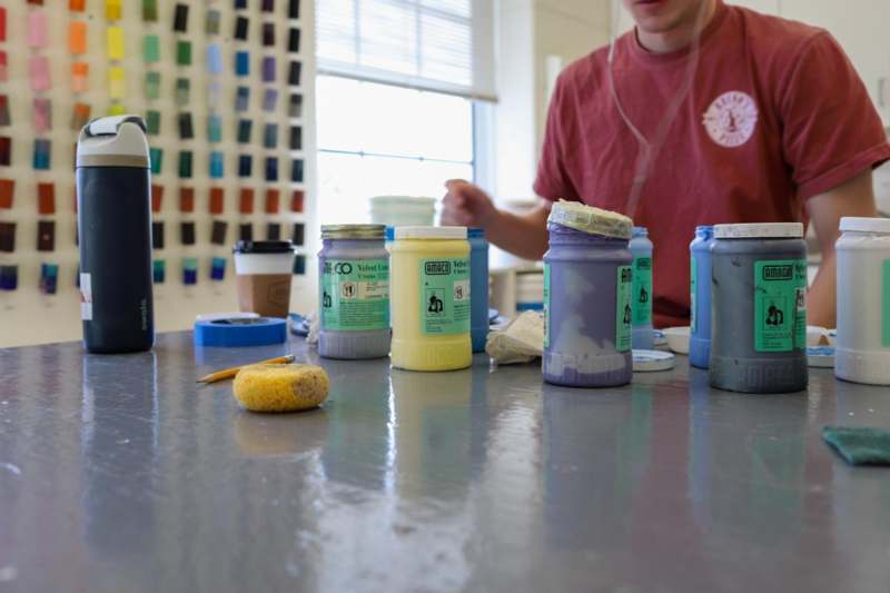 a group of jars of paint on a table