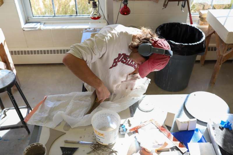 a man wearing headphones working on a piece of paper