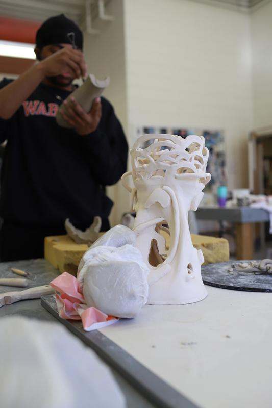 a man painting a sculpture