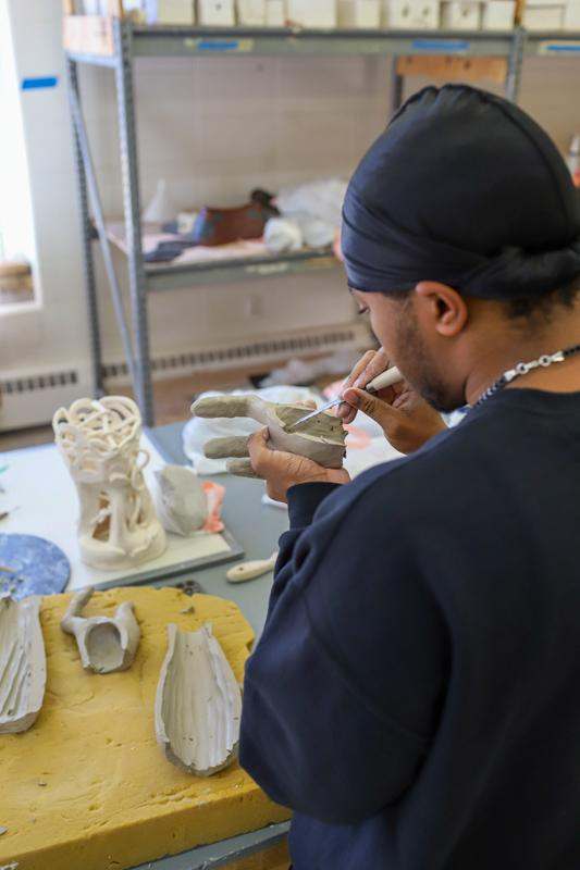 a man working on a sculpture