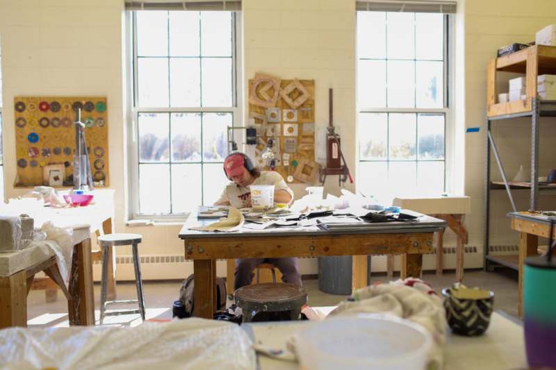 a man sitting at a table with a paper