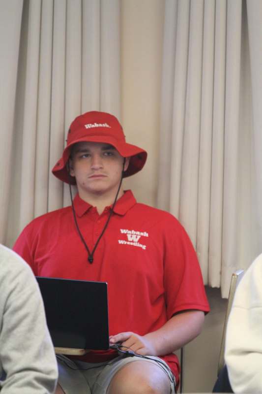 a man wearing a red shirt and hat