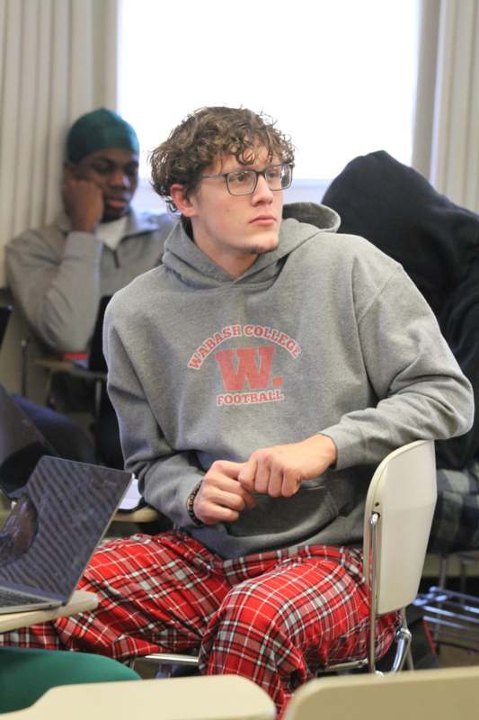 a man sitting in a chair with a laptop