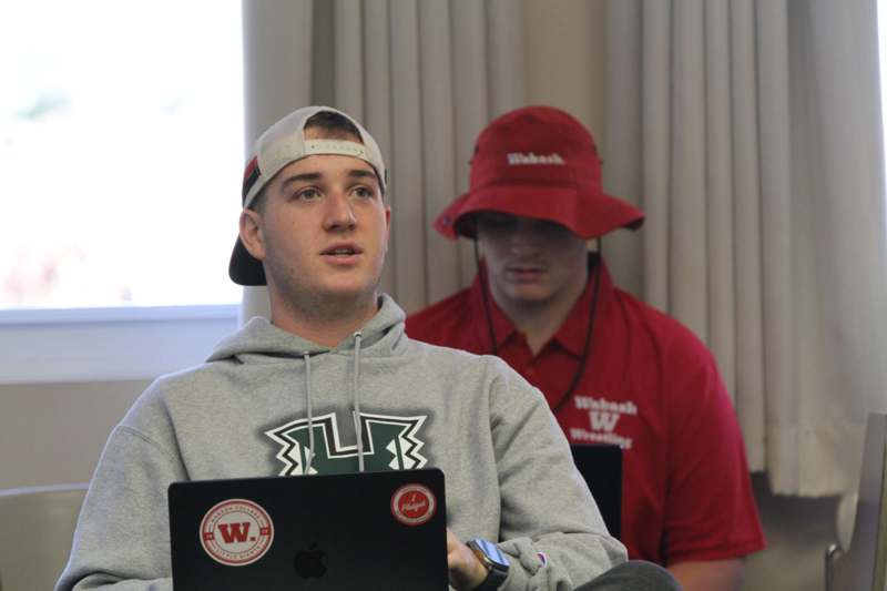 a man sitting in front of a laptop