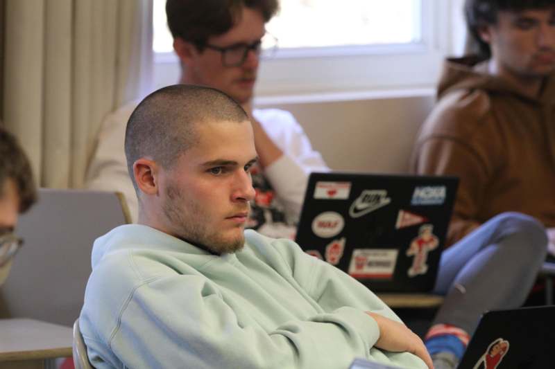 a man sitting in a chair with his arms crossed