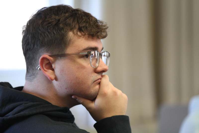 a man with his hand on his chin