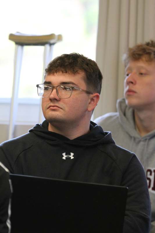 a man wearing glasses and looking at something