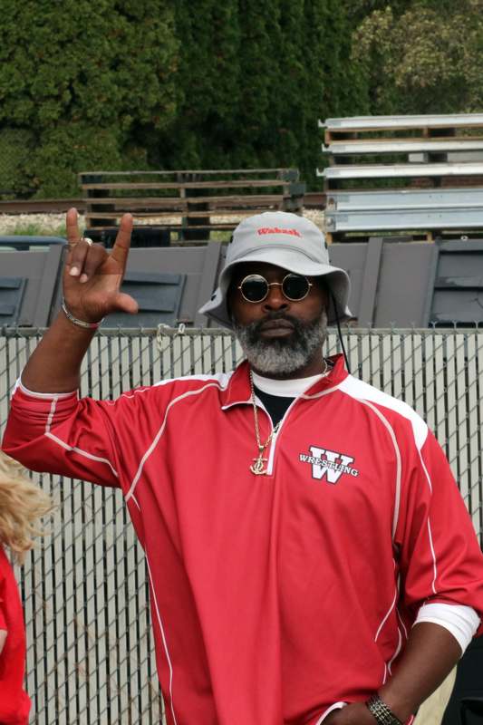 a man wearing a hat and sunglasses