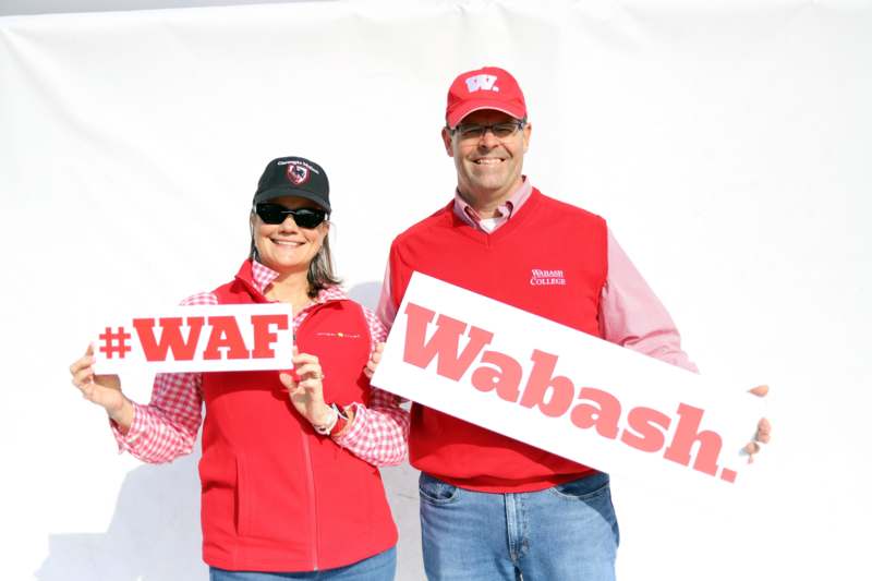 a man and woman holding signs