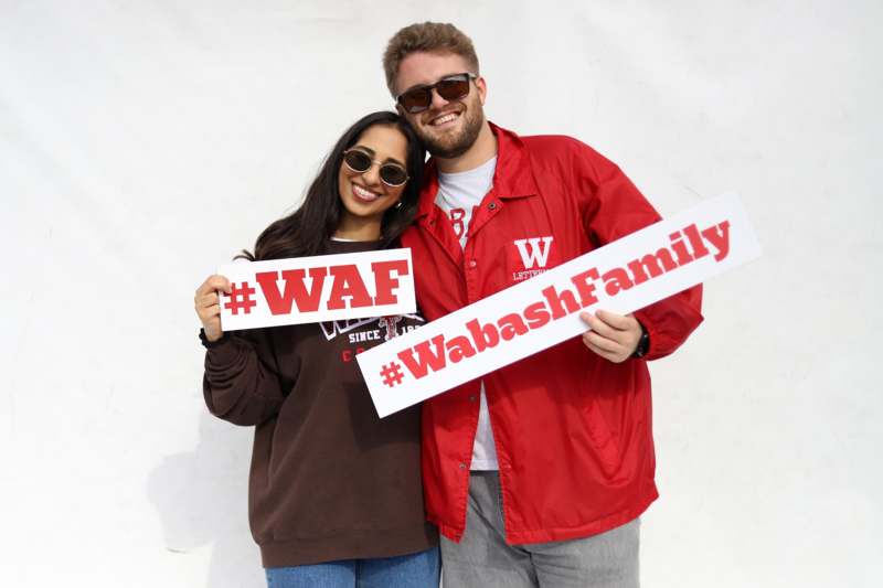 a man and woman holding signs