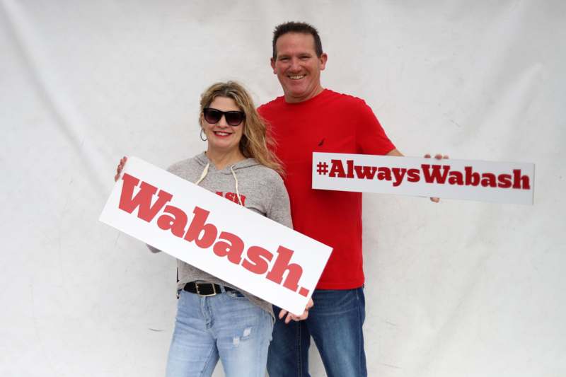 a man and woman holding signs