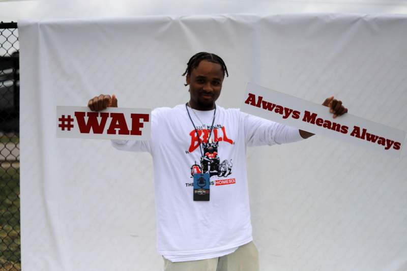 a man holding up two signs
